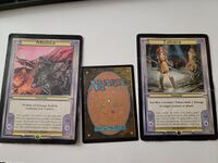 A size comparison of the Mishra and Takara cards with a standard Magic card.